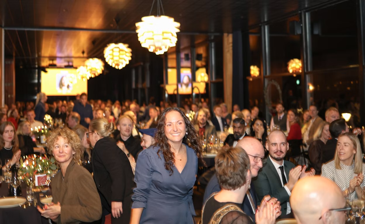 Raven's Reserve corporate gala guests seated in an elegant ballroom with chandeliers
